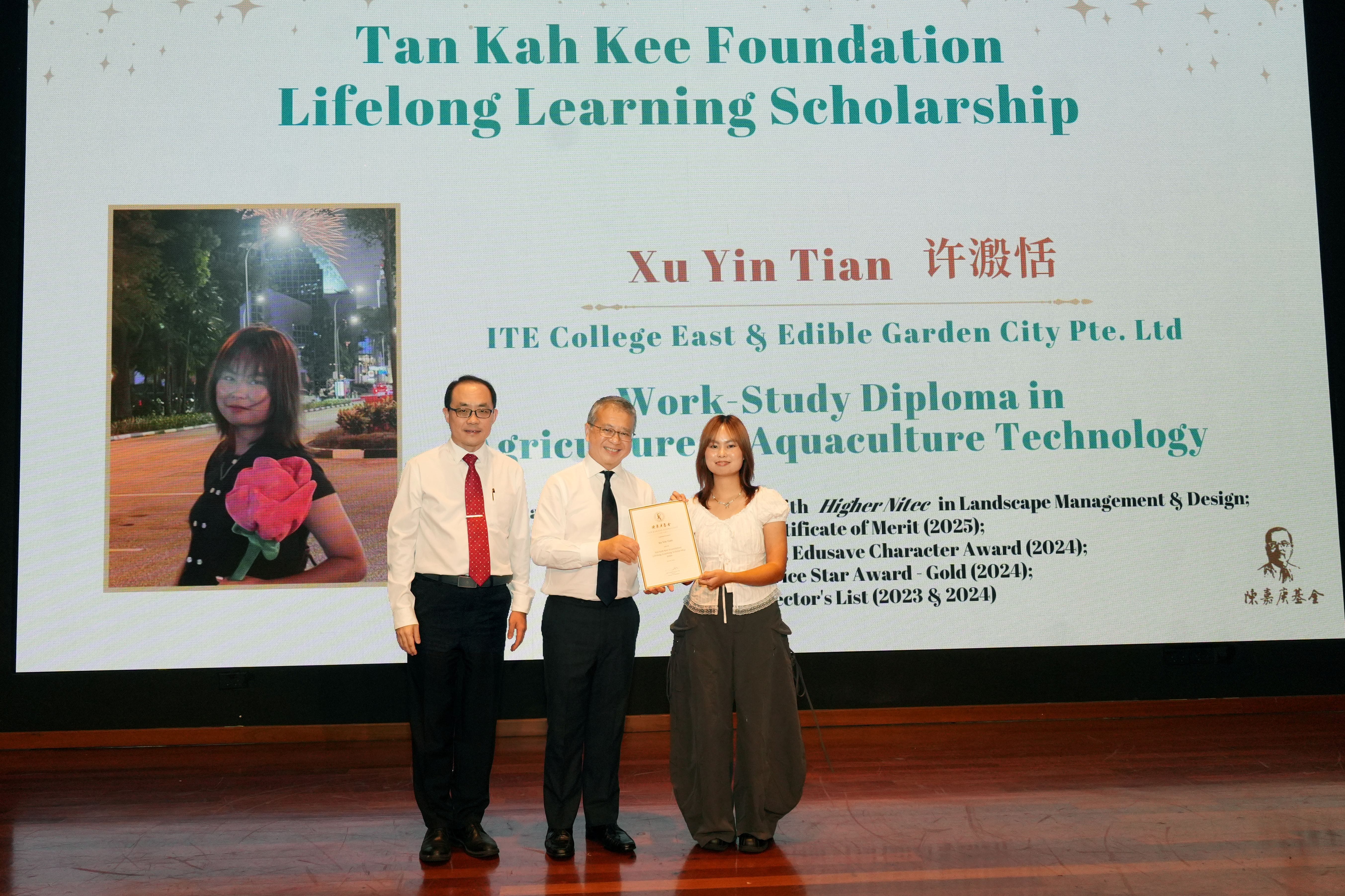 Recipient receiving scholarship on stage